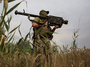 A Ukrainian soldier holds a Stinger anti-aircraft missile at a position in a front line in Mykolaiv region in August 2022.