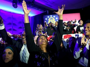 Supporters cheer as they hear the results at an election night watch party for Sen. Raphael Warnock (D-GA) at the Marriott Marquis in Atlanta on December 6, 2022. Sen. Warnock has tonight defeated his Republican challenger Herschel Walker in a runoff election.