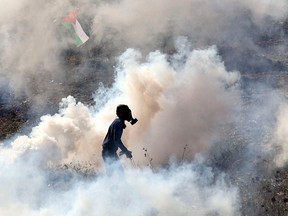 A Palestinian demonstrator stands amidst tear gas fired Friday by Israeli soldiers following a protest in Beit Dajan, east of Nablus, a city in the West Bank. Recent months have seen escalating clashes between Palestinians and Israelis. 2022 has been the bloodiest year since 2005, with 150 Palestinians killed in the West Bank and Jerusalem. Thirty Israelis have been killed in bombings, the most since 2008. Jaafar Ashtiyeh/AFP via Getty images