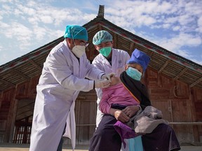 An elderly woman receives a COVID-19 vaccine in Danzhai, southwest China's Guizhou Province, December 21, 2022. Agence France Presse