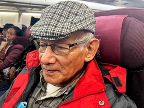 French serial killer Charles Sobhraj sits in an aircraft departing from Kathmandu to France, on Dec. 23.
