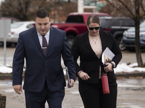 Cpl. Randy Stenger, left, and Const. Jessica Brown outside court during their jury trial on charges of manslaughter and aggravated assault in Edmonton on Friday, November 25, 2022.