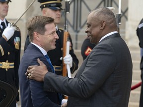 FILE - Estonia's Defense Minister Hanno Pevkur, left, is greeted by Secretary of Defense Lloyd Austin during an honor cordon ceremony, upon his arrival at the Pentagon, Tuesday, Oct. 18, 2022, in Washington. NATO member and Russia's neighbor Estonia is boosting its defense capabilities by acquiring an advanced U.S. rocket artillery system. Estonian defense officials said Saturday, Dec. 3, 2022 that the deal with the U.S. worth more than $200 million is the Baltic country's largest arms procurement project ever.