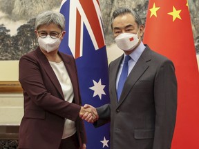 Australian Foreign Minister Penny Wong shakes hands with Chinese Foreign Minister Wang Yi in Beijing, Wednesday, Dec. 21, 2022. Australia's foreign minister is in China for talks seeking to mend a long break in high-level ties that have prompted trade sanctions and political frictions.