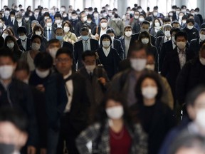 FILE - A station passageway is crowded with commuters in Tokyo, April 27, 2020. Japan's parliament approved a hefty 29 trillion yen ($216 billion) supplementary budget Friday aimed at countering the blow to household finances from rising food and utility costs and the weaker yen.