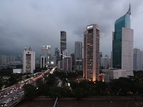 FILE - The central business district skyline is seen during the dusk in Jakarta, Indonesia, Monday, April 29, 2019. Indonesia's Parliament has passed a long-awaited and controversial revision of its penal code, Tuesday, Dec. 6, 2022, that criminalizes extramarital sex and applies to citizens and visiting foreigners alike.