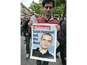 A member of a pro-Palestinian group holds a poster showing detained French-Palestinian Salah Hammouri during a gathering near the foreign ministry in Paris, Tuesday, May 5, 2009. Israel said Sunday, Dec. 18, 2022, it has deported Hammouri to France, claiming he has ties to a banned militant group.