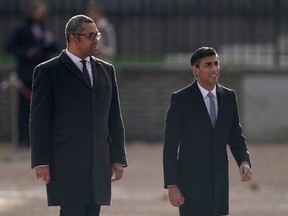 British Foreign Secretary James Cleverly and Prime Minister Rishi Sunak walk at Horse Guards Parade in London.