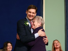 Finance Minister Katrine Conroy hugs Premier David Eby during the swearing-in ceremony at Government House in Victoria, B.C., on Wednesday, December 7, 2022. Conroy says she asked to keep her old job as British Columbia's forests minister, but Premier David Eby had other ideas and now she's in charge of managing the province's purse strings.THE CANADIAN PRESS/Chad Hipolito