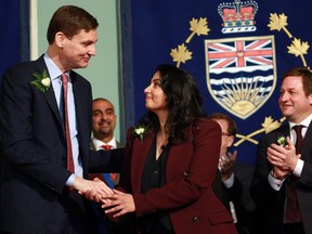 B.C. Attorney General Niki Sharma is congratulated by Premier David Eby after being sworn in during a ceremony at Government House in Victoria, B.C., on Wednesday, December 7, 2022.