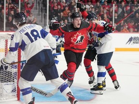 Canada's Brandt Clarke, centre, reacts after scoring a goal during second period IIHF World Junior Hockey Championship pre-tournament hockey action against Finland in Halifax on Friday, December 23, 2022.