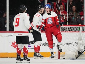 Czechia's Jaroslav Chmelar, right, celebrates a goal in front of Canada's Joshua Roy, left, and Jack Matier during second period IIHF World Junior Hockey Championship hockey action in Halifax, Monday, Dec. 26, 2022.