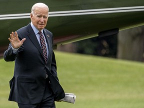President Joe Biden waves as he arrives on the South Lawn of the White House on Marine One in Washington, Friday, Dec. 16, 2022.