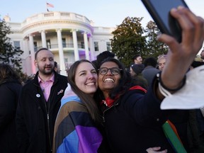 Aparna Shrivastava, right, takes a photo with her partner Shelby Teeter after President Joe Biden signed the Respect for Marriage Act, Tuesday, Dec. 13, 2022, on the South Lawn of the White House in Washington.