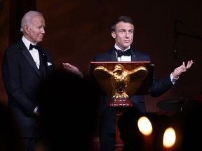 President Joe Biden listens as French President Emmanuel Macron speaks before a toast during a State Dinner on the South Lawn of the White House in Washington, Thursday, Dec. 1, 2022.