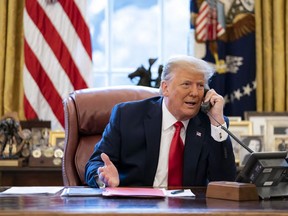 In this image released in the final report by the House select committee investigating the Jan. 6 attack on the U.S. Capitol, on Thursday, Dec. 22, 2022, President Donald Trump talks on the phone to Vice President Mike Pence from the Oval Office of the White House on the morning of Jan. 6, 2021. (House Select Committee via AP)