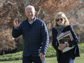 President Joe Biden and first lady Jill Biden walk on the South Lawn of the White House in Washington, upon arrival from spending the weekend at Camp David, Sunday, Dec. 4, 2022.
