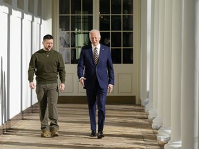 President Joe Biden and Ukrainian President Volodymyr Zelenskyy walk along the Colonnade of the White House, Wednesday, Dec. 21, 2022, in Washington.