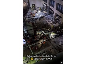 Following the burst of a huge aquarium, the atrium of a hotel is devastated in Berlin Germany, Friday, Dec. 16, 2022. German police say a huge aquarium in the center of Berlin has burst, causing a wave of devastation in and around the Sea Life tourist attraction. The words in Hebrew reads: 'The Aquarium exploded'.