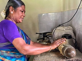 A local cook uses a spice grinder at the Bangala Hotel in Karaikudi, Chettinad, India.  Donna Kennedy-Glans