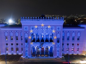 FILE - The European Union flag is projected on the National Library building in Sarajevo, Bosnia, on Oct. 12, 2022. The war in Ukraine has put the European Union's expansion at the top of the agenda as officials from the Western Balkans and EU leaders gather Tuesday for a summit intended to reinvigorate the whole enlargement process.