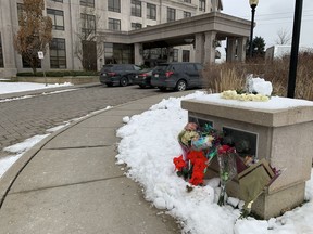 Floral tributes are shown outside a condo building in Vaughan, Ont., Tuesday, Dec. 20, 2022.&ampnbsp;Heartfelt tributes are pouring in for the five people who were killed over the weekend after a 73-year-old man went door to door gunning down his victims in a Toronto-area condo.&ampnbsp;THE CANADIAN PRESS/Fakiha Baig