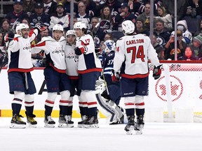 Washington Capitals' Evgeny Kuznetsov (92) celebrates his goal against the Winnipeg Jets with Alex Ovechkin (8), Conor Sheary (73), Dylan Strome (17) and John Carlson (74) during second period NHL action in Winnipeg, Sunday, Dec. 11, 2022.