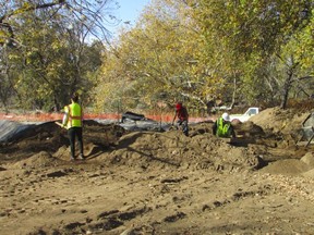 In this photo provided by Shawna Garcia, monitors working with the Wintu Tribe of Northern California search for remains and artifacts at a construction site on Nov. 30, 2022, where a trail and parking area along the Sacramento River will soon open in Redding, Calif. Ancestors of the tribe were buried near the site, but the tribe says it didn't receive proper notification about construction plans from the federal agency running the project.