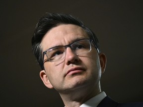 Conservative Leader Pierre Poilievre listens to a question during a media availability on Parliament Hill in Ottawa, Friday, Dec. 30, 2022.