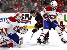 Ottawa Senators left wing Brady Tkachuk (7) tries to find the bouncing puck between Montreal Canadiens goaltender Sam Montembeault (35) and defenceman Joel Edmundson (44) during second period NHL hockey action in Ottawa, on Wednesday, Dec. 14, 2022.
