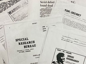 Pages from the RCMP file on defector Sergei Kourdakov, a Russian seaman who turned up bloody and exhausted on the British Columbia coast in September 1971 are photographed in Ottawa on Wednesday, Dec. 21, 2022. The Canadian Security Intelligence Service, which assumed counter-espionage duties from the Mounties in 1984, released the 802-page file to