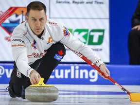 Canada skip Brad Gushue makes a shot during the men's gold medal game against Korea at the Pan Continental Curling Championships in Calgary, Alta., Sunday, Nov. 6, 2022. Gushue and Matt Dunstone dropped their opening games Tuesday at the Grand Slam of Curling's Masters event.