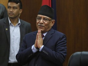 FILE- Leader of communist party Nepal, Pushpa Kamal Dahal greets the gathering after announcing his resignation as prime minister, in line with an agreement made with his coalition partner party, in Kathmandu, Nepal, Wednesday, May 24, 2017. The leader of former communist rebels has become Nepal's new prime minister with the support from his ex-opponent and other smaller political parties. The announcement was made by the office of President Bidhya Devi Bhandari on Sunday after the Maoist communist party leader Pushpa Kamal Dahal met her to stake his claim for the prime minister following last month's elections.