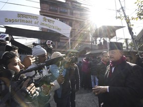 Charles Sobhraj's lawyer Gopal Siwakoti, right, talks to media outside immigration office, in Kathmandu, Nepal, Friday, Dec. 23, 2022. Confessed French serial killer Charles Sobhraj has been released from prison in Nepal after serving most of his sentence. Sobhraj was driven out of Central Jail in Kathmandu to the Department of Immigration under heavy guard Friday after the Supreme Court ordered him to be released because of poor health and good behavior.