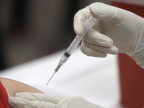 Aa patient receives an influenza vaccine in Mesquite, Texas, on Thursday, Jan. 23, 2020. At least five children died in British Columbia from influenza last month alone, a rise that comes as an early season of respiratory illnesses adds strain to the beleaguered health-care system.THE CANADIAN PRESS/AP/LM Otero