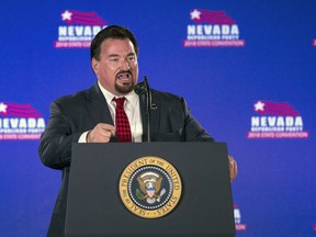 FILE - Nevada State GOP Chairman Michael McDonald announces President Donald Trump before he speaks the Nevada Republican Party Convention at the Suncoast Hotel and Casino Saturday, June 23, 2018, in Las Vegas. New transcripts released on Wednesday, Dec. 21, 2022, by the House Jan. 6 committee reveals Donald Trump and his allies played a direct role in the Nevada Republican Party's phony elector scheme in 2020. The transcripts show McDonald invoked his Fifth Amendment protection 275 times when he was interviewed in February.