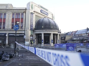 The scene outside Brixton O2 Academy where police are investigating the circumstances which led to four people sustaining critical injuries in an apparent crush as a large crowd tried to force their way into the south London concert venue, Friday Dec. 16, 2022. Four people were hospitalized in critical condition on Friday after a suspected crush at a London concert venue, where Nigerian singer Asake was performing.