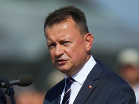 FILE - Defense Minister of Poland Mariusz Blaszczak answers questions to media after signing an air policing treaty at an airshow in Malacky, Slovakia, Aug. 27, 2022. Blaszczak on Tuesday, Dec. 6 says his country will accept a Patriot missile defense system which Germany offered to Poland last month. The German offer was made after an errant missile fell in Poland near the border with Ukraine, killing two Polish men.