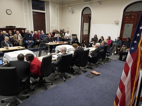 CORRECTS NAME TO CHERYL AMIRAULT LEFAVE, NOT CHERYL LEFAVE-AMIRAULT - A Statehouse panel, foreground, convenes, Tuesday, Dec. 13, 2022, at the Statehouse, in Boston, to weigh whether to approve Mass. Gov. Charlie Baker's recommended pardons of two individuals at the center of one the nation's most high-profile sexual abuse trials of the 1980s. Gerald "Tooky" Amirault, his sister, Cheryl Amirault LeFave were convicted in 1986 and 1987 along with their late mother, Violet, of abusing young children at their Fells Acres Day Care in Malden.