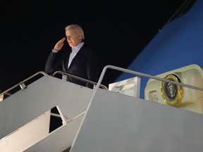 President Joe Biden salutes as he boards Air Force One at Andrews Air Force Base, Md., on Tuesday, Dec. 27, 2022. Biden and his family are traveling to St. Croix, U.S. Virgin Islands, to celebrate New Year.