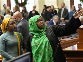 State Reps. Mana Abdi, D-Lewiston, left, and Deqa Dhalac, D-South Portland, attend their first session of the Maine Legislature, Wednesday, Dec. 7, 2022, in Augusta, Maine. They are the first Somali-Americans elected to the Maine Legislature.