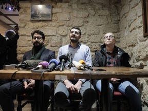 From left to right, members of the Kurdish community David Andic, Agit Polat lawyer of the Kurdish Democratic Counsel in France and Berivan Firat attend a media conference near the crime scene where the shooting took place in Paris, Friday, Dec. 24, 2022. A shooting targeting a Kurdish cultural center in Paris Friday left three people dead and three others wounded, authorities said.