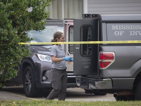 Mississippi Bureau of of Investigations investigators inspected a police vehicle on the scene of the murder of two police officers outside a Motel 6 in Bay St. Louis on Tuesday, Dec. 13, 2022. Police say a woman shot and killed two officers before killing herself.