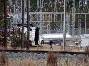 Workers work on equipment at the West End Substation, at 6910 NC Hwy 211 in West End, N.C., Monday, Dec. 5, 2022, where a serious attack on critical infrastructure has caused a power outage to many around Southern Pines, N.C.