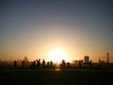 People watch the sunrise from the top of Primrose Hill in London, Britain. 