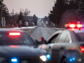 Members of the Ontario Provincial Police close off a section of Indian Line near Hagersville, Ont., Wednesday, Dec. 28, 2022, where an OPP officer was shot and killed.