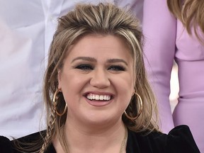 FILE - Musical artist Kelly Clarkson smiles on the Hollywood Walk of Fame during a ceremony in her honor on Monday, Sept. 19, 2022, in Los Angeles. Clarkson will host the 12th annual NFL Honors awards show Feb. 9 in Phoenix, recognizing the league's best players, performances and plays from the 2022 season.