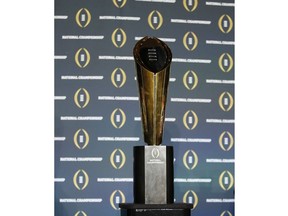 FILE - The national championship trophy is seen before a new conference for the NCAA college football playoff championship game between Clemson and Alabama, Sunday, Jan. 10, 2016, in Glendale, Ariz. The College Football Playoff announced Thursday, Dec. 1, 2022, it will expand to a 12-team event, starting in 2024, finally completing an 18-month process that was fraught with delays and disagreements.The announcement comes a day after the Rose Bowl agreed to amend its contract for the 2024 and '25 seasons, the last hurdle CFP officials needed cleared to triple the size of what is now a four-team format.