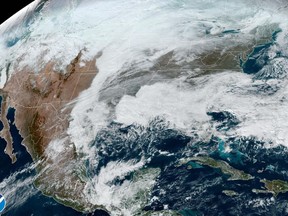 This satellite image made available by NOAA shows cloud cover over North America on Wednesday, Dec. 21, 2022 at 1:31 p.m. An arctic blast is bringing extreme cold, heavy snow and intense wind across much of the U.S. this week -- just in time for the holidays. (NOAA via AP)
