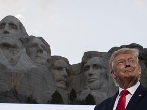 FILE - Then-President Donald Trump stands at Mount Rushmore National Memorial on July 3, 2020, near Keystone, S.D. South Dakota prosecutors have dropped all charges against the head of an Indigenous-led advocacy organization stemming from a protest during Trump's visit to Mount Rushmore in 2020, the group announced Tuesday, Dec. 13, 2022.